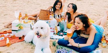 girls at the beach with dog